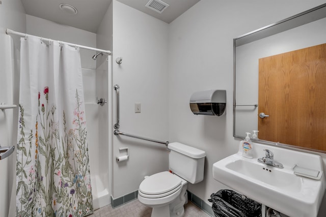 bathroom featuring toilet, sink, and walk in shower