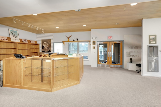 kitchen with wooden ceiling, carpet floors, and track lighting