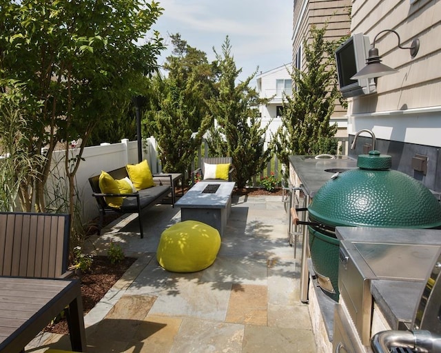 view of patio featuring outdoor lounge area, grilling area, and a wet bar