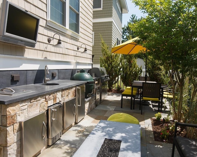 view of patio / terrace with exterior kitchen, sink, and grilling area