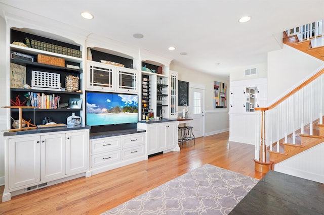 living room with sink and light hardwood / wood-style floors