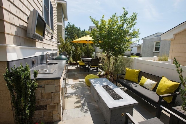 view of patio / terrace featuring area for grilling and an outdoor living space with a fire pit