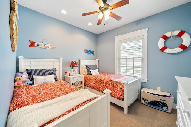 bedroom with ceiling fan and light carpet