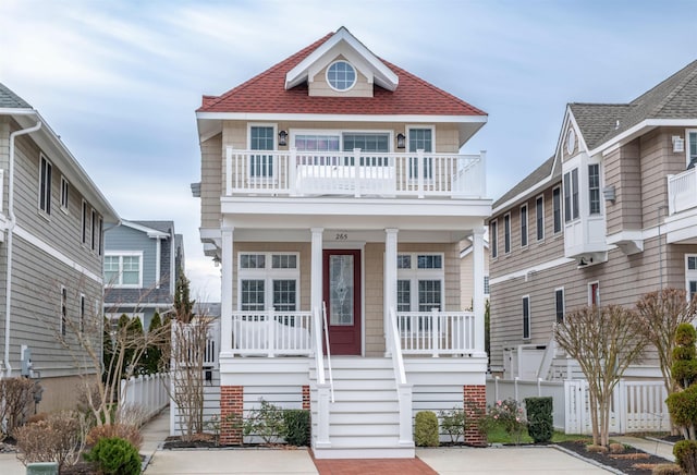 view of front of property with covered porch and a balcony