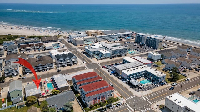 bird's eye view featuring a water view and a view of the beach