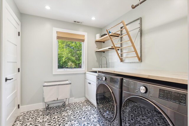 401 Fern Rd, Cape May Beach, NJ 08251 - laundry area with separate washer and dryer, baseboards, cabinet space, recessed lighting, and light tile patterned flooring