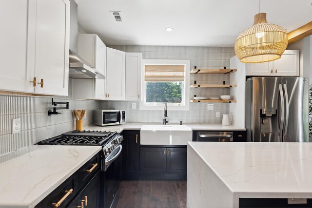 401 Fern Rd, Cape May Beach, NJ 08251 - kitchen with appliances with stainless steel finishes, a sink, dark wood-style flooring, backsplash, and dark cabinetry