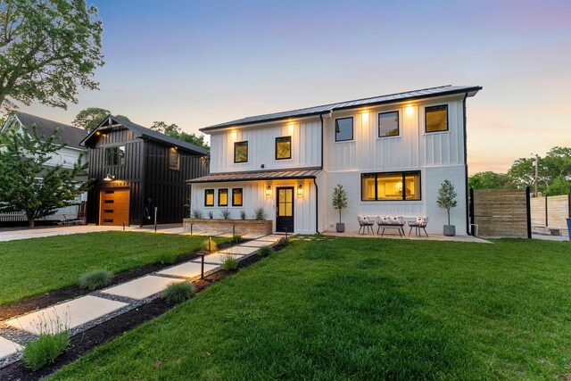401 Fern Rd, Cape May Beach, NJ 08251 - modern farmhouse style home featuring a standing seam roof, board and batten siding, metal roof, concrete driveway, and a garage