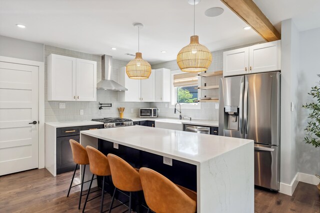 401 Fern Rd, Cape May Beach, NJ 08251 - kitchen with appliances with stainless steel finishes, wall chimney exhaust hood, a sink, dark wood-type flooring, and decorative backsplash
