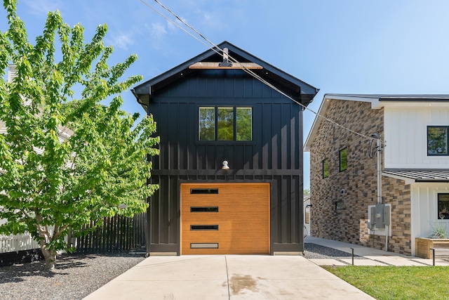 401 Fern Rd, Cape May Beach, NJ 08251 - modern inspired farmhouse featuring driveway, stone siding, board and batten siding, and an attached garage