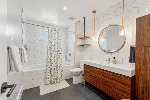 401 Fern Rd, Cape May Beach, NJ 08251 - bathroom featuring tiled shower / bath combo, tile walls, tile patterned flooring, vanity, and toilet