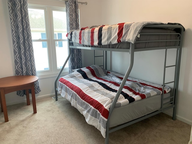 bedroom featuring multiple windows and light colored carpet