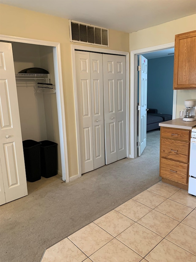 unfurnished bedroom featuring light carpet