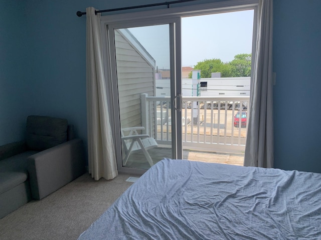 carpeted bedroom featuring multiple windows