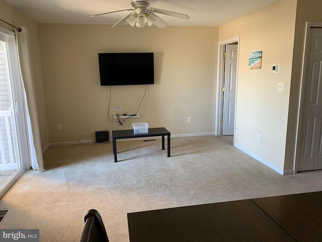 interior space with ceiling fan and light carpet