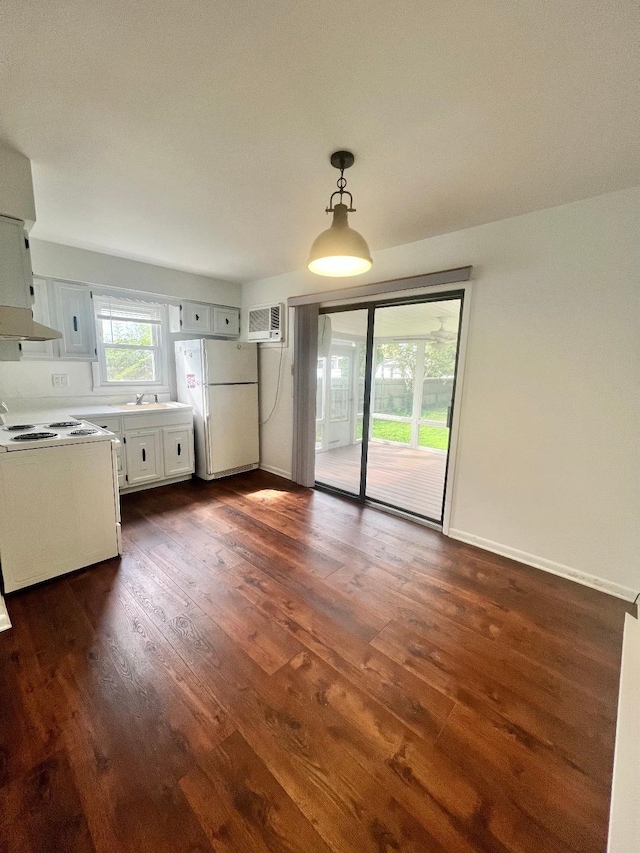 106 Cedardale Ave, Villas, NJ 08251 - kitchen with white appliances, premium range hood, dark wood-type flooring, hanging light fixtures, and a wall mounted air conditioner