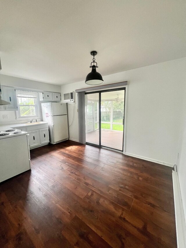 106 Cedardale Ave, Villas, NJ 08251 - unfurnished living room with dark wood-style floors, a wall mounted AC, and a baseboard radiator