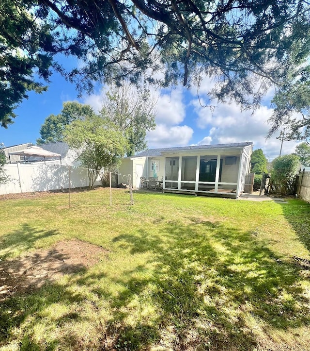 106 Cedardale Ave, Villas, NJ 08251 - rear view of house with a sunroom and a fenced backyard
