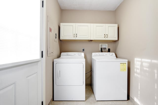 washroom featuring cabinet space, independent washer and dryer, baseboards, and light tile patterned floors