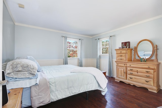 bedroom with ornamental molding, dark wood-type flooring, and wainscoting