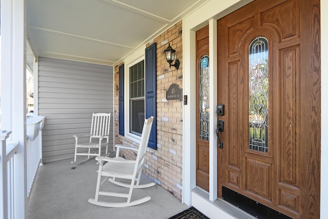 view of exterior entry featuring brick siding