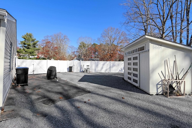 exterior space with a fenced backyard and an outdoor structure