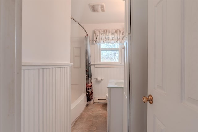 bathroom with visible vents, a baseboard radiator, shower / tub combo with curtain, vanity, and a wainscoted wall