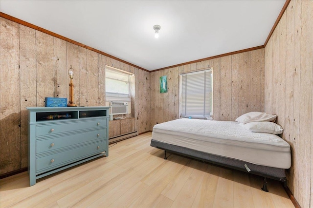 bedroom featuring a baseboard radiator, cooling unit, ornamental molding, and light hardwood / wood-style floors