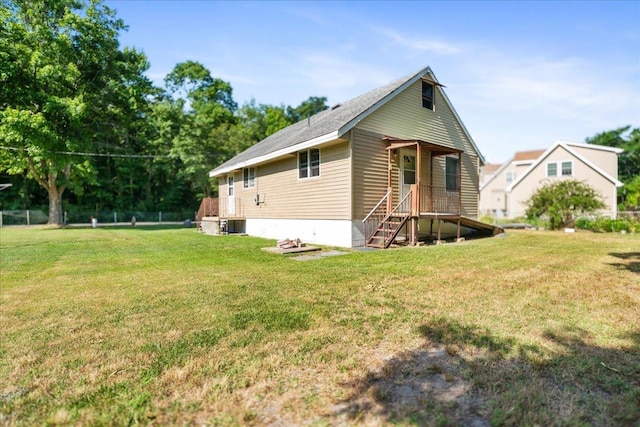 rear view of house featuring a yard