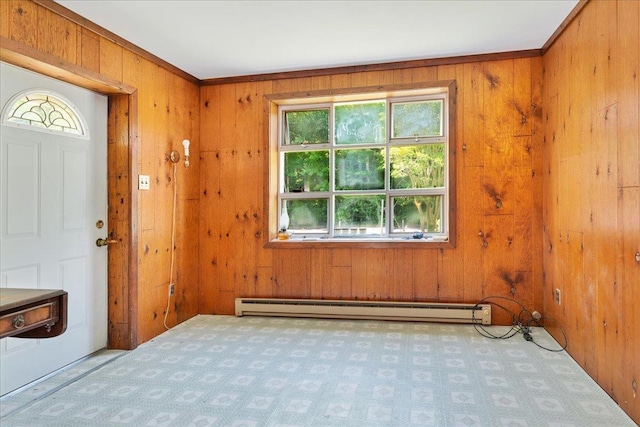 entrance foyer featuring light carpet, a baseboard radiator, and wooden walls