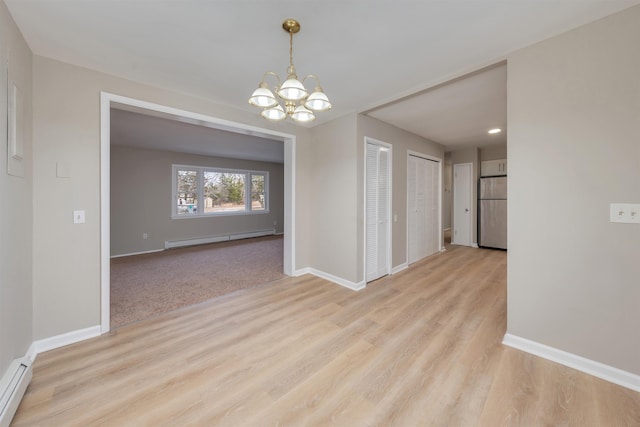 unfurnished dining area featuring a baseboard radiator, a notable chandelier, and light wood-type flooring