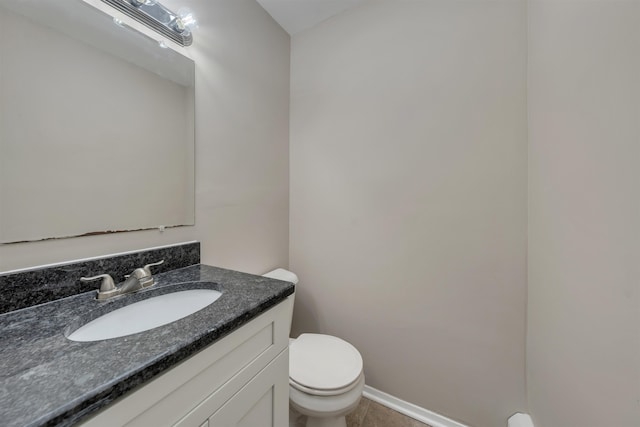 bathroom with tile patterned flooring, vanity, and toilet