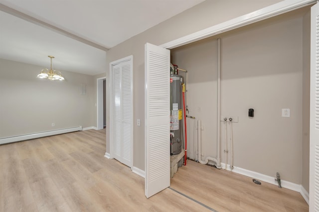 laundry area with light hardwood / wood-style flooring, gas water heater, a baseboard radiator, and a chandelier