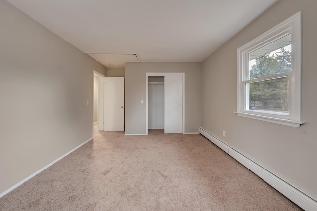 unfurnished bedroom featuring a baseboard heating unit and a closet