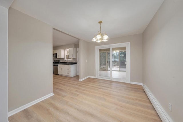 unfurnished dining area featuring a baseboard heating unit, a chandelier, and light hardwood / wood-style floors