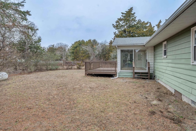 view of yard featuring a deck and a sunroom