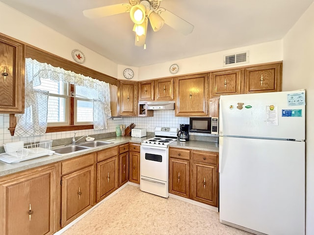 kitchen featuring ceiling fan, decorative backsplash, sink, and white appliances