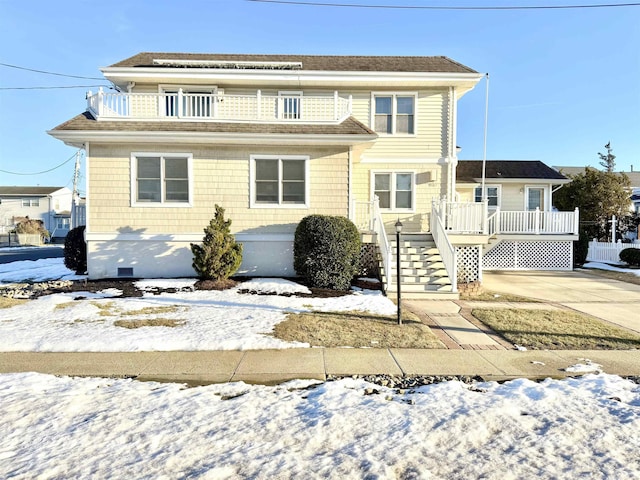 view of front property featuring a balcony