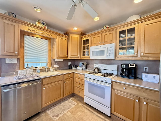 kitchen featuring ceiling fan, sink, and white appliances