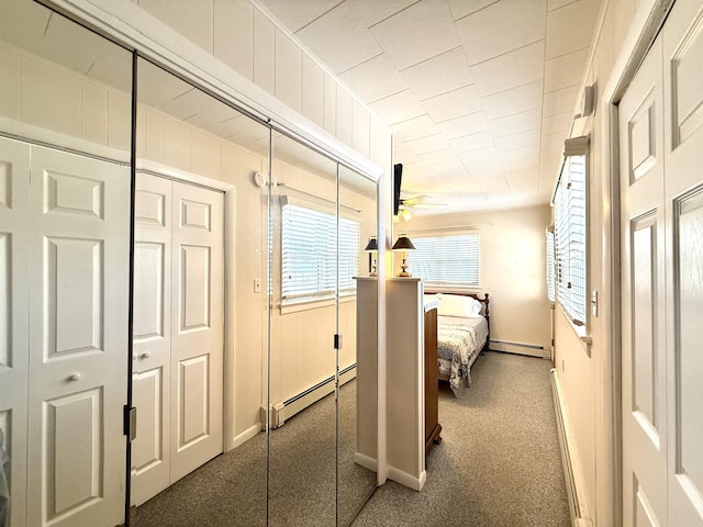 bedroom featuring dark colored carpet and a baseboard radiator