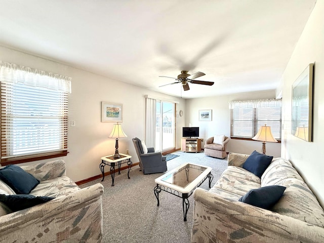 carpeted living room with ceiling fan