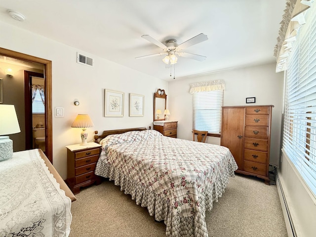 carpeted bedroom featuring ceiling fan and a baseboard heating unit