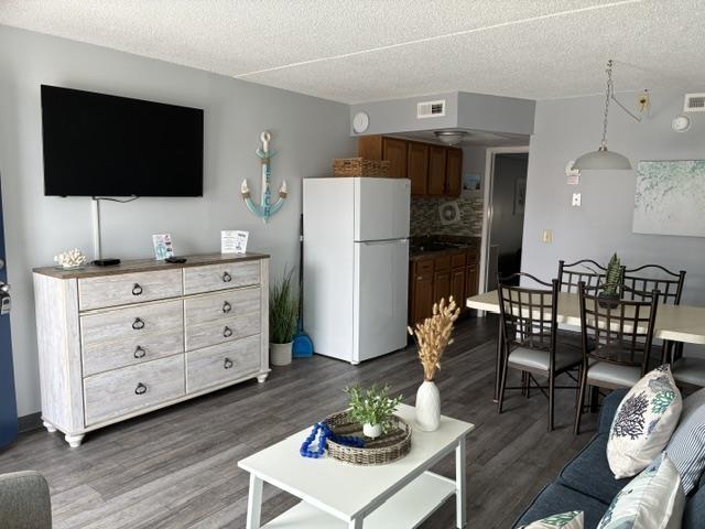 9101 Atlantic Ave Unit 303, Wildwood Crest, NJ 08260 - living room featuring dark wood finished floors and a textured ceiling