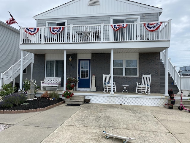 103 W Topeka Ave Unit 2, Wildwood Crest, NJ 08260 - view of front of house featuring brick siding, a porch, stairway, and a balcony