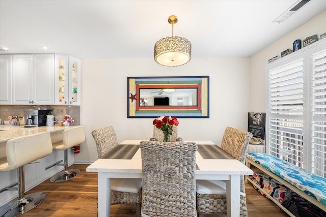 dining space with dark wood-type flooring