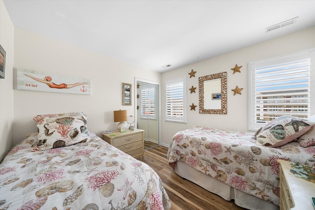 bedroom with dark hardwood / wood-style flooring