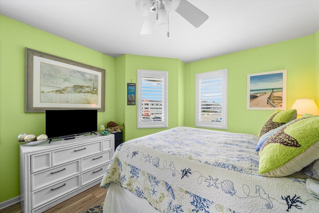 bedroom with ceiling fan and dark wood-type flooring