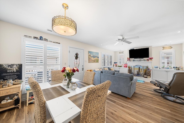 dining space featuring ceiling fan and light wood-type flooring