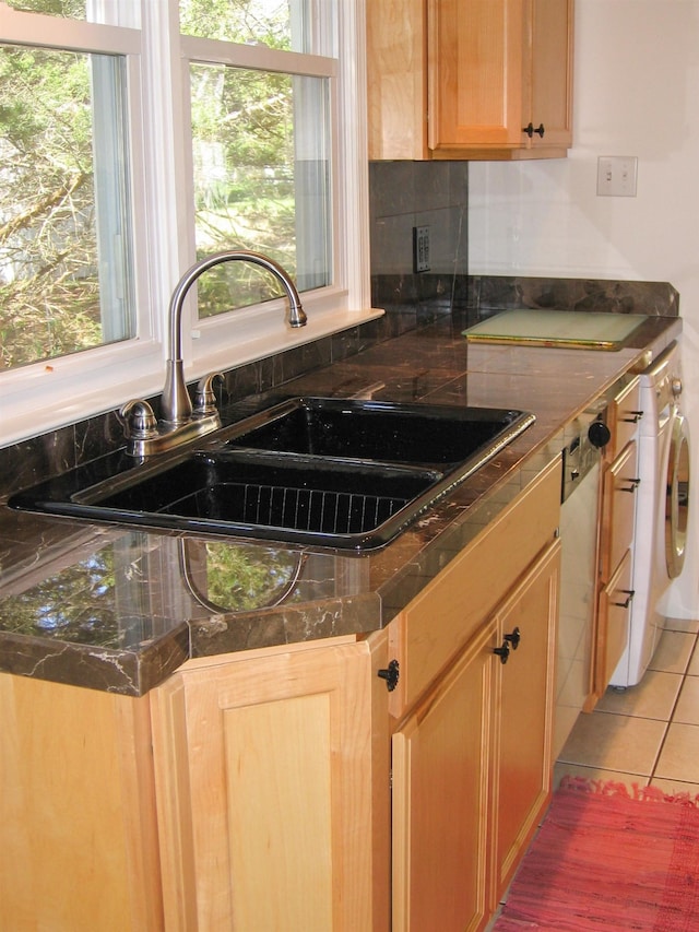 kitchen with tile patterned floors, sink, and a healthy amount of sunlight