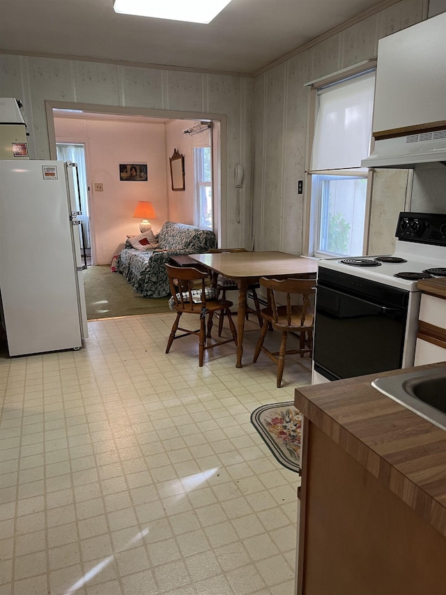 149 E Florida Ave, Villas, NJ 08251 - kitchen featuring freestanding refrigerator, electric range, under cabinet range hood, light flooring, and plenty of natural light
